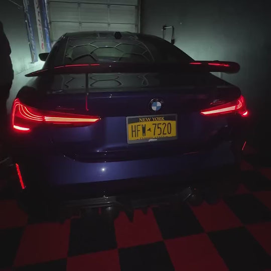 Fantom blackout license plate switching from clear to black on a BMW M3 at night